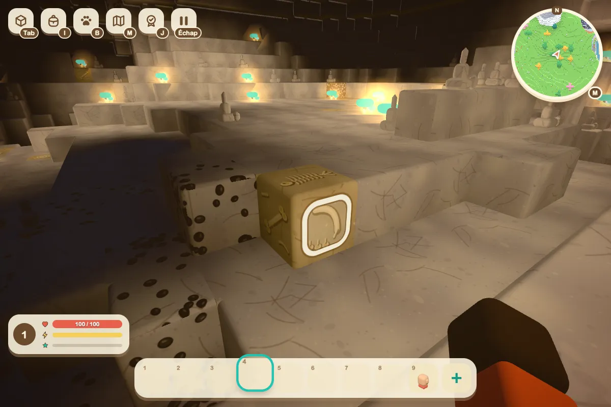 A yellow block of fossil rock with bone drawings, in the foreground of a cave.