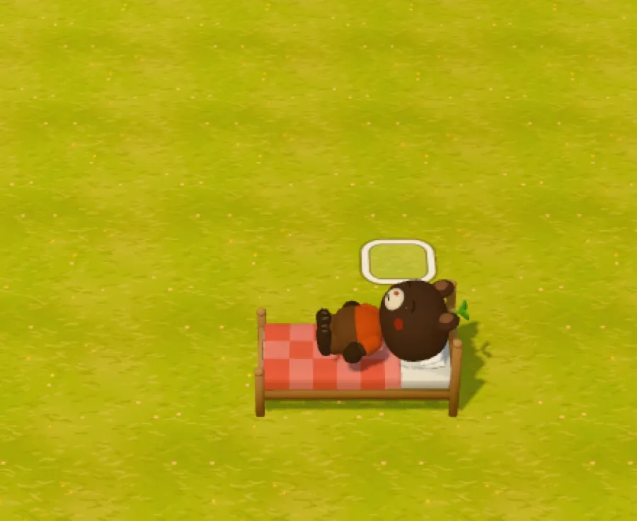 The bear lying in a bed with a red checked blanket, head resting on the white pillow.